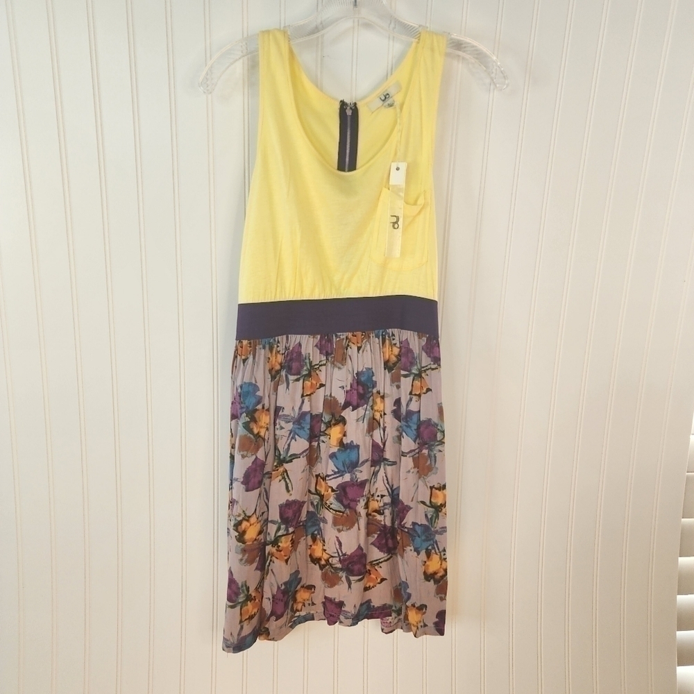 Ya sleeveless yellow top with bold multi colored bottom in a floral pattern.